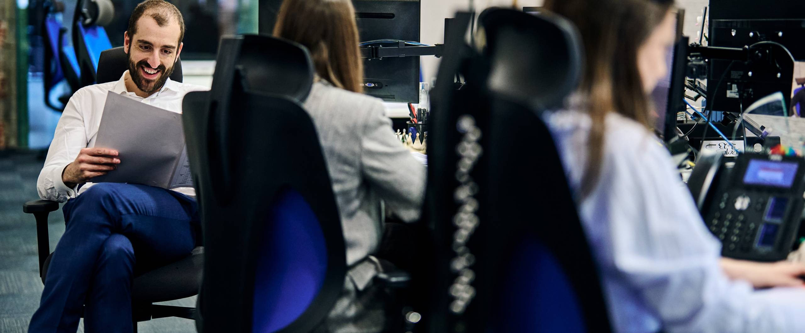 colleagues chatting and smiling in a modern office environment