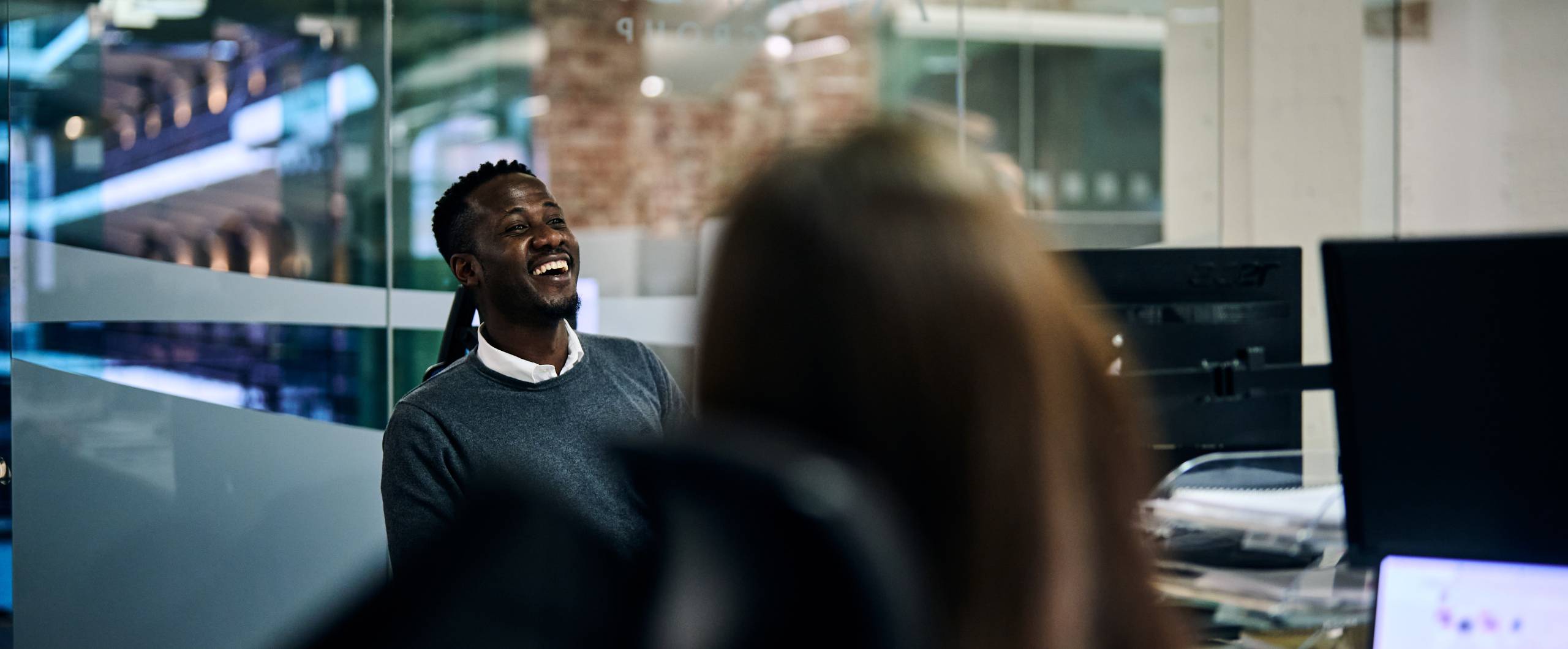 Man smiling at his desk 
